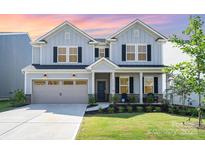 Charming two-story home with a well-manicured lawn and inviting front porch at 11116 Godwit Ln, Charlotte, NC 28278