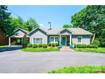 Charming single-story home with a well-maintained gray brick exterior and lush landscaping at 2024 5Th Street Nw Pl, Hickory, NC 28601