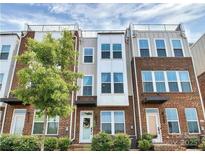 Attractive brick townhome featuring multi-pane windows and a private rooftop terrace at 268 Parkwood Ave, Charlotte, NC 28206