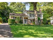 Charming two-story home with a beautifully landscaped front yard and a mix of brick and siding at 4200 Tyndale Ave, Charlotte, NC 28210