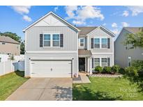 Charming two-story home featuring a gray siding, attached garage, and well-maintained landscaping at 4313 Gibbon Crossing Dr, Charlotte, NC 28269