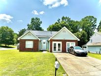 Charming one-story brick home featuring an attached garage and a well-manicured front lawn at 5728 Rocbridge Ln, Charlotte, NC 28208
