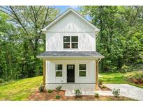Charming two-story home with white siding, a covered porch, and simple landscaping at 605 Poplar St, Shelby, NC 28150