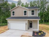 Charming two-story home featuring neutral siding, a two-car garage, and a manicured lawn at 823 32Nd Ne St, Conover, NC 28613