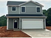 Charming two-story home with gray siding, white trim, black door, and attached two car garage at 823 32Nd Ne St, Conover, NC 28613