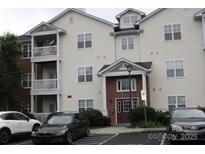 Well-maintained condo building features two stories and a parking lot at 9823 Hyde Glen Ct, Charlotte, NC 28262