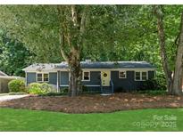 Charming single-story home featuring a freshly painted exterior, landscaped yard, and a welcoming front entrance at 1027 Dresden W Dr, Charlotte, NC 28205