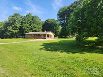 Ranch-style brick home with large front yard and mature trees at 10414 Tillman Steen Rd, Indian Land, SC 29720