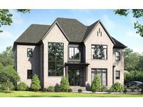 Beautiful gray brick home with black trim, lush lawn and mature landscaping at 1321 Ferncliff Rd, Charlotte, NC 28211