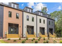 Modern townhomes feature varied colors, gray doors and wood stairs, enhancing curb appeal at 1356 Briar Creek Rd, Charlotte, NC 28205