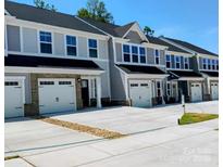 Modern townhome exteriors with attached garages and contemporary design, showcasing curb appeal and convenient parking at 1598 Respect St, Concord, NC 28027