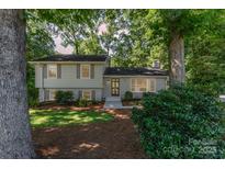 Charming home with a well-maintained lawn, mature trees, and inviting front entrance at 4014 Sulkirk Rd, Charlotte, NC 28210