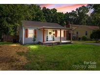 Charming single-story home featuring a welcoming front porch and shuttered windows at 405 E 18Th St, Kannapolis, NC 28083