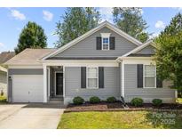Charming one-story home features gray siding, black shutters, and a well-manicured lawn at 7315 Gasper Ln, Fort Mill, SC 29707