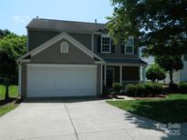 Charming two-story home with a two-car garage and well-maintained landscaping at 10516 Pickerel Ln, Charlotte, NC 28213