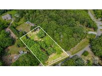 Expansive lot with mature trees, outlined in white, offers privacy and natural beauty at 11201 Johnson Davis Rd, Huntersville, NC 28078