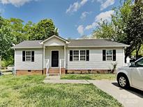 Charming single-story home featuring a welcoming entrance, black shutters, and well-maintained lawn at 120 Todd Nw Dr, Concord, NC 28025