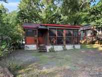 Charming exterior featuring a screened-in front porch, providing a cozy outdoor living space at 160/162 Arrowood Trl # F28/F29, Mount Gilead, NC 27306
