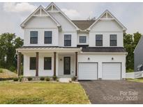 Stunning two-story home with a two-car garage, covered porch, and stylish curb appeal at 236 Paradise Dr, Belmont, NC 28012