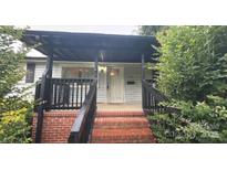Charming home featuring a welcoming front porch with brick steps and dark wood railings at 307 Elm St, Belmont, NC 28012