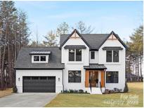 Stunning two-story home with a modern black-and-white design, gray roof, and beautifully landscaped front yard at 3119 Shenandoah Ave, Charlotte, NC 28205