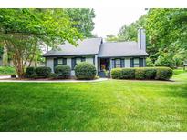 Charming single-Gathering home featuring lush landscaping and a well-manicured lawn at 3221 5Th Street Nw Ct, Hickory, NC 28601