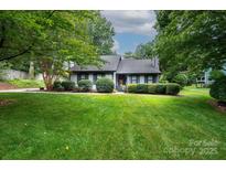 Charming single-story home with lush green lawn and manicured landscaping at 3221 5Th Street Nw Ct, Hickory, NC 28601