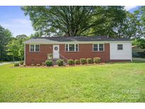 Charming brick home with manicured lawn and inviting front porch at 346 Fieldstone Cir, Statesville, NC 28677