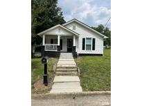 Charming home with classic details, a welcoming front porch, and a well-manicured lawn at 512 S Gray St, Gastonia, NC 28052