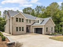Magnificent two-story brick home featuring a spacious driveway and an attached two-car garage at 5217 Waterfall Ct, Gastonia, NC 28056