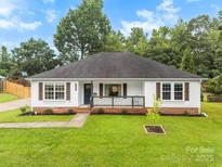 Charming one-story home with a well-maintained lawn and inviting front porch at 7144 Marlin St, Gastonia, NC 28056