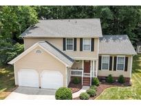 Charming two-story home features a manicured lawn, a two-car garage, and a welcoming front porch at 7212 Morsey Ct, Charlotte, NC 28269
