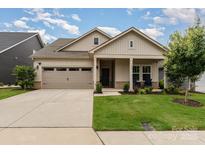 Charming single Gathering home with a manicured lawn, two-car garage, and inviting front porch at 9274 Dunwich Dr, Gastonia, NC 28056