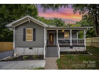 Charming bungalow-style home featuring a cozy front porch and freshly landscaped front yard at 952 Salisbury St, Wadesboro, NC 28170
