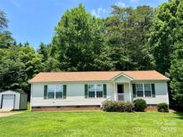Charming single-story home with green shutters, well-maintained lawn and storage shed at 1031 Daniel Dr, Stanley, NC 28164