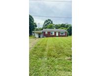 Charming brick ranch home featuring a covered side-entrance and spacious front yard at 1073 Springdale Dr, Maiden, NC 28650