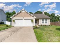 Charming single-story home featuring an attached two-car garage and well-maintained front lawn at 12829 Brandenburg Ln, Midland, NC 28107