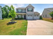 Charming two-story home with a well-manicured lawn and a two-car garage at 210 Clove Hitch Dr, Salisbury, NC 28677