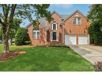 Beautiful brick home with a manicured lawn and a two-car garage, perfect for Gathering living at 2321 Oberwood Dr, Charlotte, NC 28270