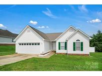 Charming single-story home with white siding, a manicured lawn, and an attached two-car garage at 2467 Hawk Ridge Dr, Gastonia, NC 28056