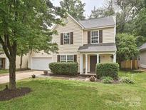Charming two-story home featuring a well-manicured lawn, attached two-car garage, and inviting front porch at 2848 Huckleberry Hill Dr, Fort Mill, SC 29715