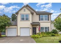 Charming two-story home with a well-maintained front yard, two-car garage, and welcoming front door at 3304 Saddlebrook Dr, Midland, NC 28107