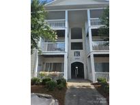 Inviting condominium entrance with multiple levels and manicured landscaping, offering a warm welcome at 3944 Town Center Rd, Harrisburg, NC 28075