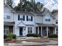 Charming two-story townhouse with manicured landscaping and a welcoming entrance at 5650 Kimmerly Woods Dr, Charlotte, NC 28215