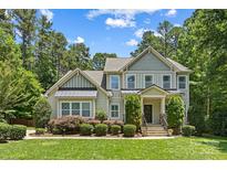Charming two-story home featuring manicured landscaping, neutral siding, and a welcoming front porch at 6422 Northern Red Oak Dr, Mint Hill, NC 28227