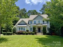 Charming two-story home with well-manicured lawn and lush landscaping at 6422 Northern Red Oak Dr, Mint Hill, NC 28227