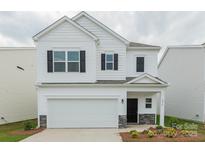 Charming two-story home with a two-car garage and well-manicured landscaping at 1272 Langston Ln, Salisbury, NC 28144