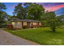Charming brick home with manicured lawn and mature landscaping, offering great curb appeal at 1321 Arbor Dr, Salisbury, NC 28144