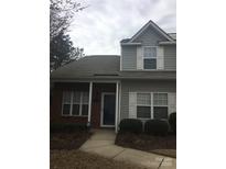 Charming home with gray siding, brick accents, and white trim on a cloudy day at 136 Mangum Cir, Mooresville, NC 28117