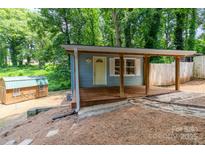 Charming home with a covered porch, wooden shed, and natural surroundings at 140 Fairway Ln, Gastonia, NC 28216